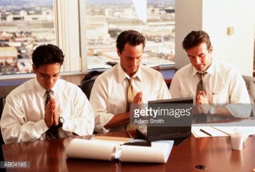 Three Business Men Praying to Laptop - Adam Smith.