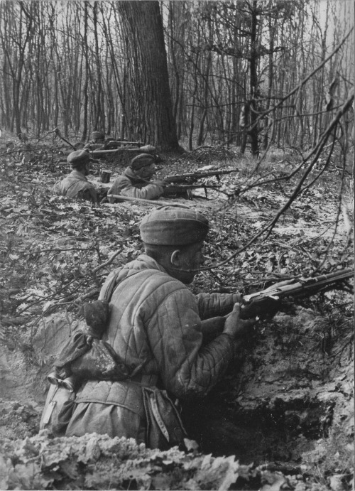 Red Army soldiers positioned within trenches on the outskirts of Berlin in April, 1945. A captured G