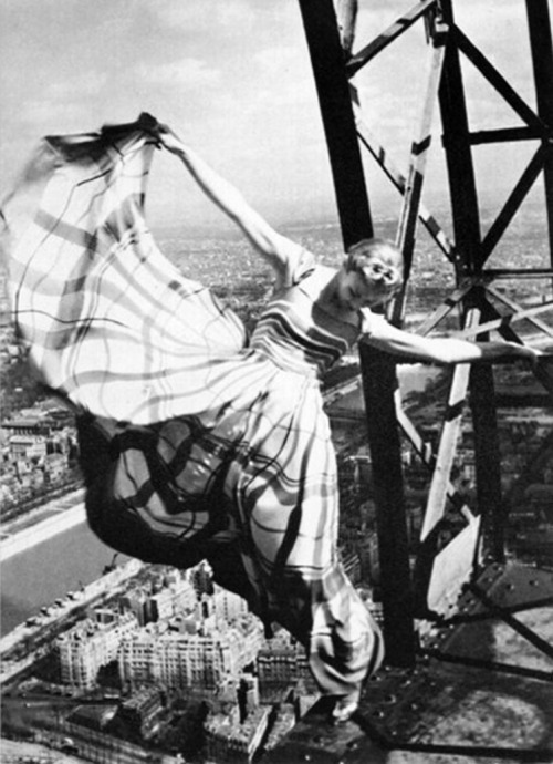 Erwin Blumenfeld - An iconic photo of Lisa Fonssagrives-Penn in a Lucien Lelong gown swinging precariously off the Eiffel Tower, for Vogue 1939.