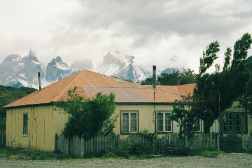 Ranch house, peaks of Torres del Paine behind, Parque Nacional Torres del Paine, Chile. The house is