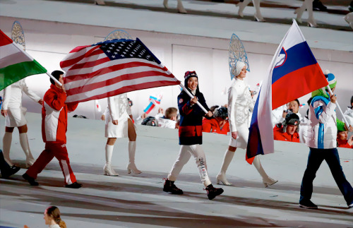 Hockey player Julie Chu of the United States enters with the flag during the 2014 Sochi Winter Olymp