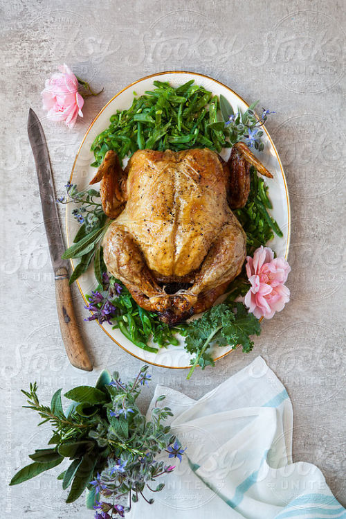 Roast chicken and green beans, decorated with flowers and herbs By NadineGreeffAvailable to license 