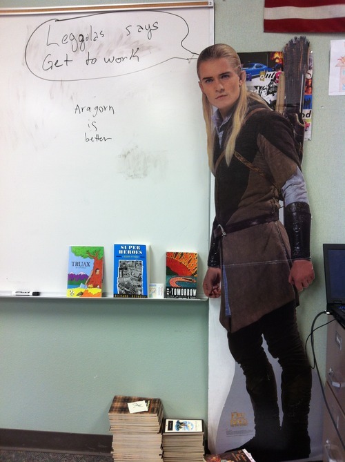 sammysamwinchester:  so it was recently my language arts teacher’s birthday, and one of his students brought him a cardboard cutout of legolas that now just sits in various places in our classroom, like today  