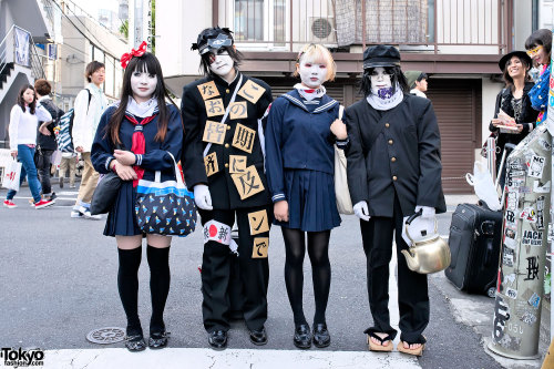 Shironuri in Japanese school uniforms - w/ metal teapot, eye patch &amp; geta - on the street in
