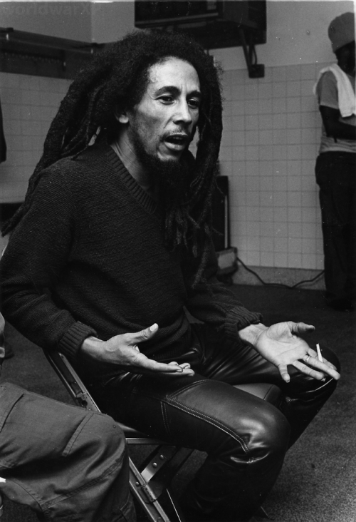 Rare photographs of Bob Marley being interviewed and playing football with friends backstage at the 