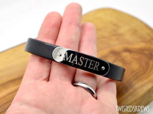 twistedskrews:  Custom engraved:Up to 2 lines20 characters PER LINE (including spaces)This adjustable two layer cuff features Stainless Steel for the bottom layer (against the skin) and black genuine leather as the top layer. Adored with a stainless steel