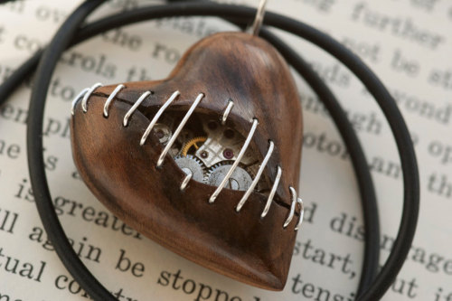 wickedclothes:  Stitched Clockwork Heart Pendants Sometimes our hearts get ripped apart at the seams. Luckily, time heals all wounds. Carved out of various woods, these heart pendants are filled with old watch parts. Sold on Etsy. 