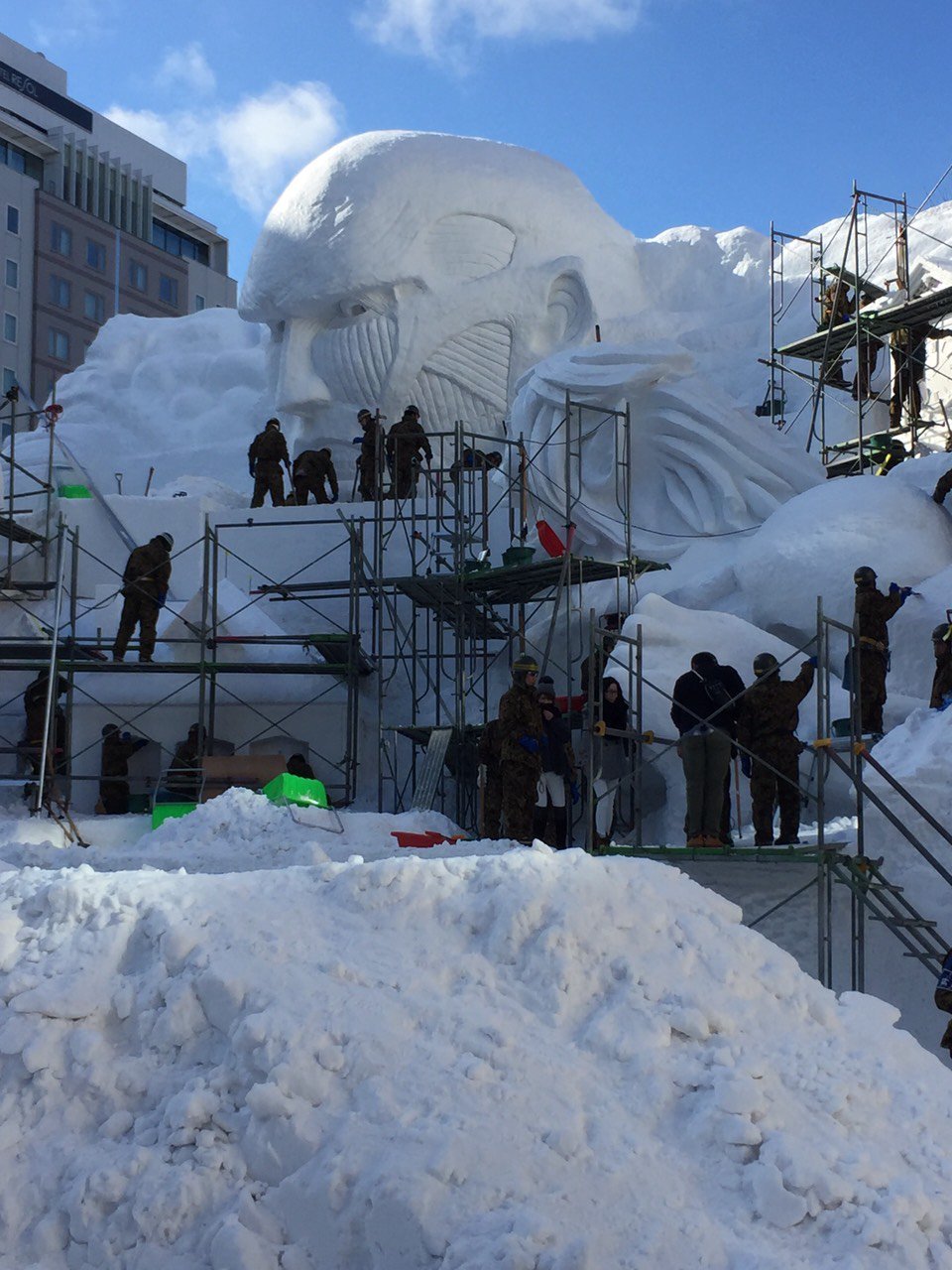 Close-ups of the Colossal Titan model and actual snow sculpture under construction,