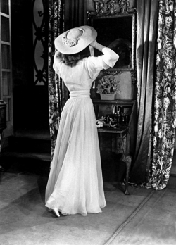 onlyoldphotography:  Alfred Eisenstaedt: Actress Katharine Hepburn, adjusting her hat in mirror while in costume on set of her Broadway play “The Philadelphia Story”. 1941 