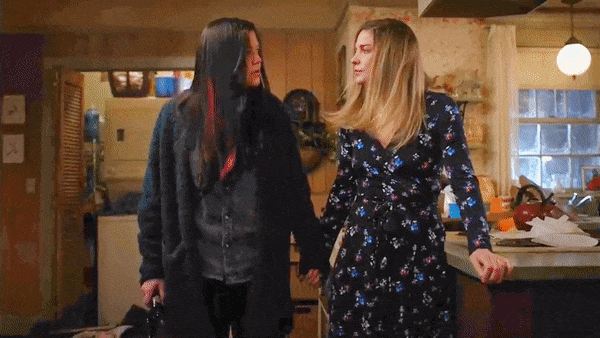 Patty and Allison looking at each other and then at Neil after Patty hit him over the head