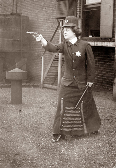 A suffragette posed in police uniform to illustrate the concept of a policewoman, Cincinnati, Ohio c