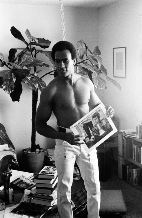 At Home, Huey P. Newton Listens to Bob Dylan's High 61 Revisited, Berkley, 1970 photograph