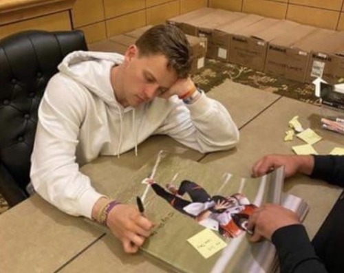 This Picture Is Hilarious He Looks SO OVER IT (look At The Stack He Had To Go Through)