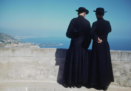 vintageeveryday:Two priests looking over a wall at a view of Monte Carlo, Monaco, August 1948. Photo