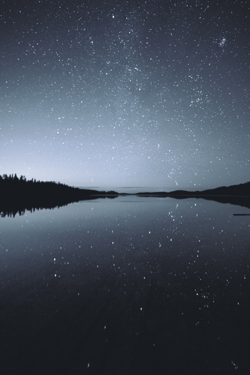 tiinatormanenphotography: Night sky reflecting on the surface of a lake.  I took this picture a few 