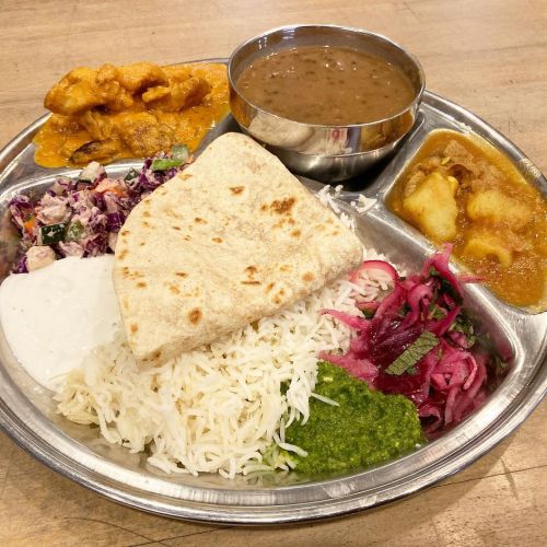 Thali plate with chicken tikka masala, lamb curry, daal lentils, basmati rice, roti.  San Francisco 