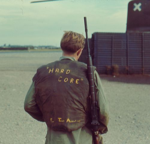 vietnamwarera:witold-dagger:Soldier in Vietnam with written captions on his Kevlar vest“Hard Core” a