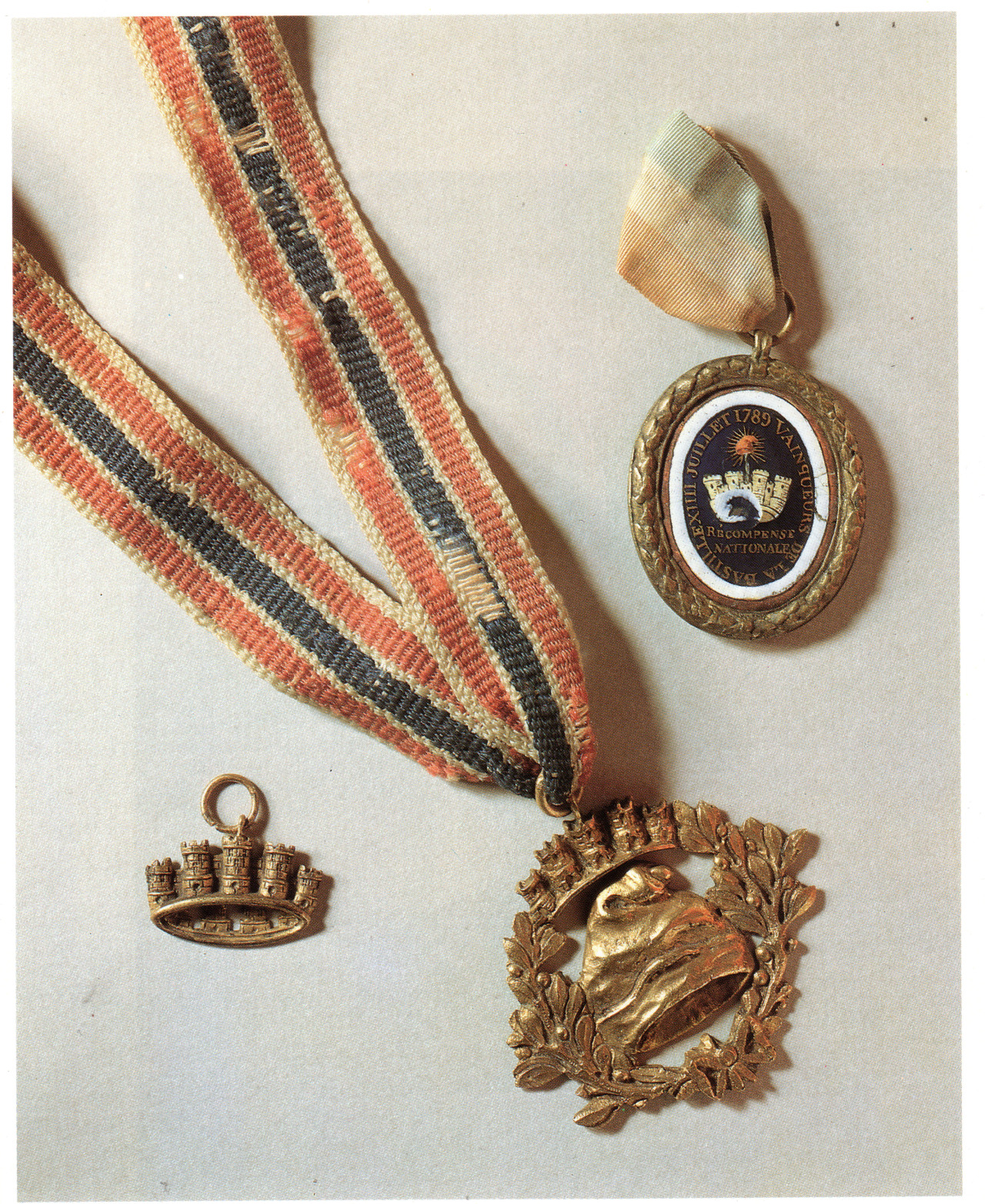bunniesandbeheadings:  Insignia and medals on gilded bronze awarded to Bastille conquerors. From The