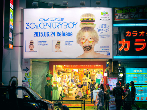 Kondo Yohji “30th Century Boy” billboard on the street in Harajuku at night.