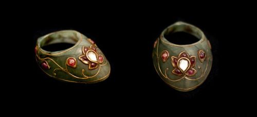 Jade archers thumb ring, used to draw a bowstring using a thumb draw. Decorated with gold, rubies, a