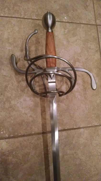 wearefighter: A few pictures of my rapier, spurred by chatting about fencing with @wearebard. Darkwood Armories, three-ring swept hilt rapier with cherry handle and a 39″ practice blade (with a blunt, hence the wonky-looking tip). 46″ total length,