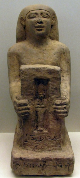 Statue of Nakhtanubis, priest of Osiris, shown holding a miniature shrine with an effigy of Osiris. 