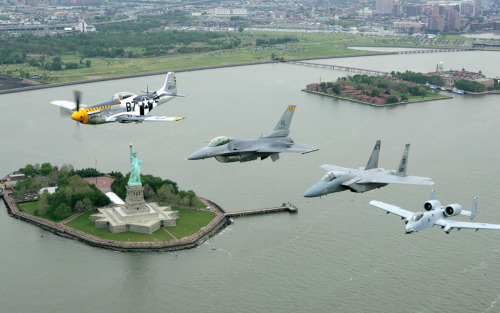militaryarmament:  A P-51 Mustang, F-16 Fighting Falcon, F-15C, and an A-10 Thunderbolt II flying over New York harbor and the Statue of Liberty in a Heritage Flight Formation.