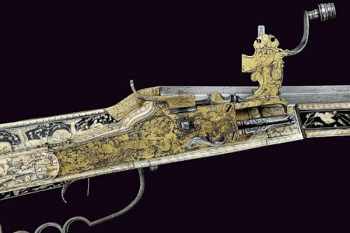 A beautiful 17th century wheel-lock rifle decorated with bone, silver, and gold.  Most likely G