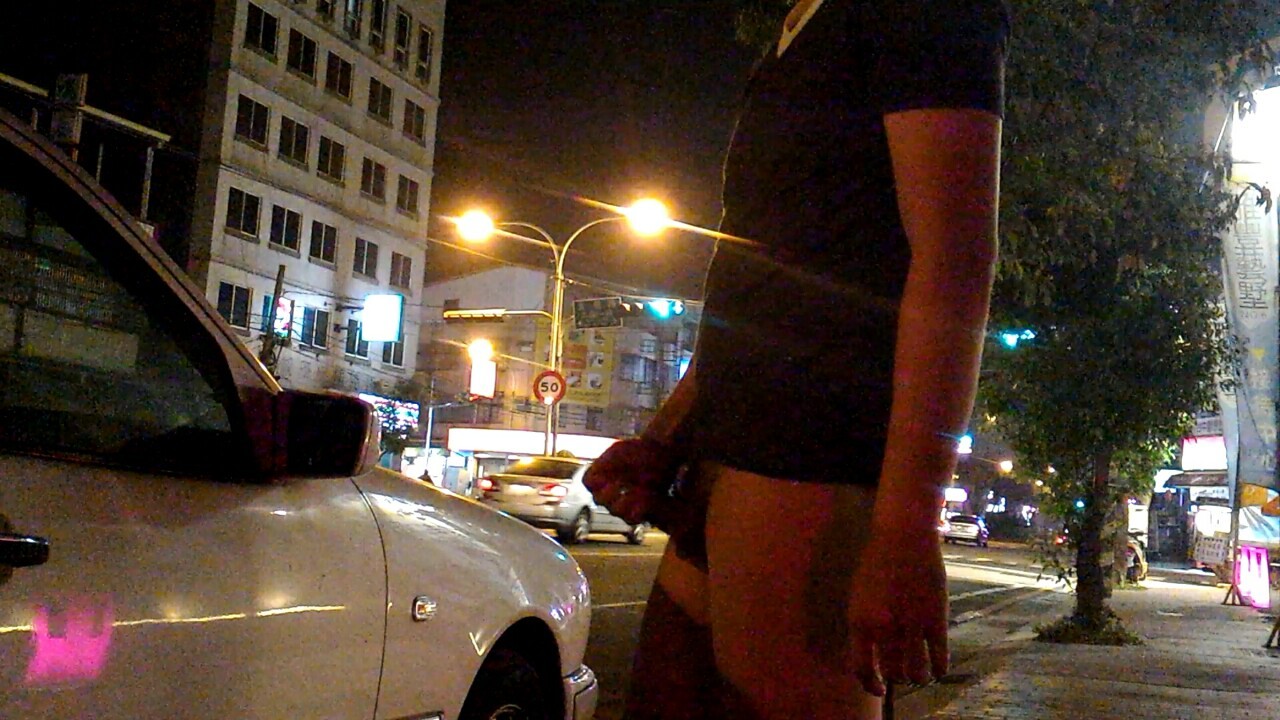 A naked Asian man shows off his hard cock, and masturbates, near a busy city intersection!