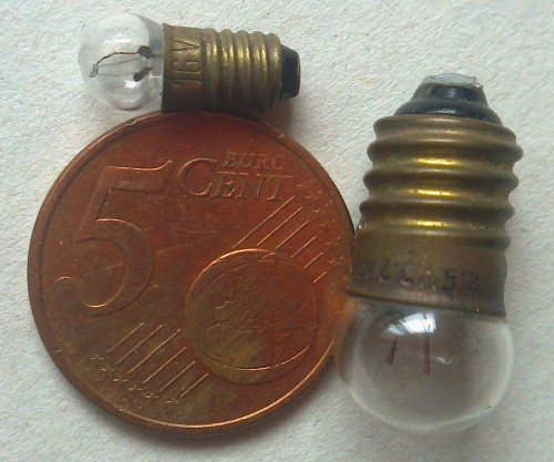 Very tiny light bulb, with 5 cent coin and E10 flashlight bulb for comparison [1404x1171] [OC]