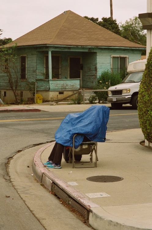 phdonohue: woman under blue tarp | los angeles, california ig: phdonohue 