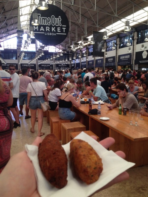 Tasting bacalhau croquettes at the Time Out market, Lisbon, Portugal