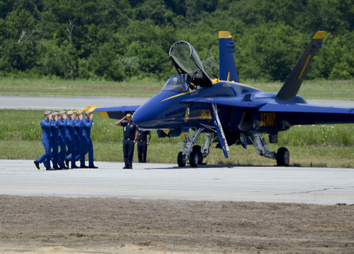 retrowar:    Pilots assigned to the U.S. Navy flight demonstration squadron, the Blue Angels, walk down the flightline prior to a practice demonstration before the Pax River Air Expo on Naval Air Station Patuxent River.  