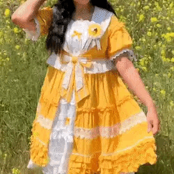 A gif of a person showing off a yellow and white frilly lolita style dress. The gif cuts off the legs and the face of the person.