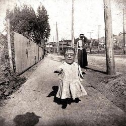  a little girl in a Frankenstein mask-circa