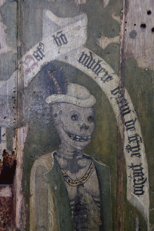 The remainder of a Rood Screen (circa 14th C)  shows the dance of death with the Latin inscriptions: