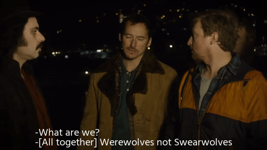 gif from the what we do in the shadows movie, a group of men stood around, captioned: "What are we? / [All together] Werewolves not swearwolves"