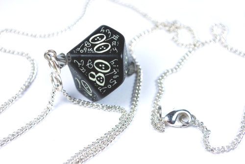 This is a beautiful Black D10 (10 sided die) with white ornately printed elvish numbers. It is surro