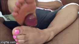 A chubby ebony with cute pink toes giving a nice footjob