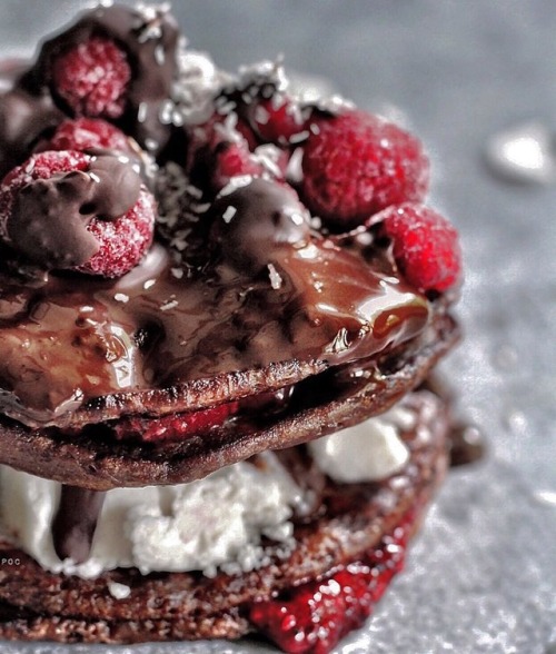 Chocolate pancakes with chilled coconut cream, hot chocolate sauce alternated with chia seed raspber