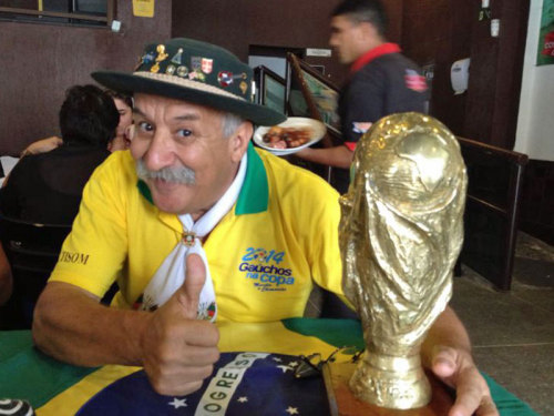 Trivia from the “sad guy with a mythical moustache holding the World Cup trophy”, and some happy pictures of him! His name is Clovis Acosta Fernandes, also known as “Gaúcho da Copa”. He’s 59 years old and works as a real