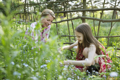 Mother and Daughter gardening by Mint Images