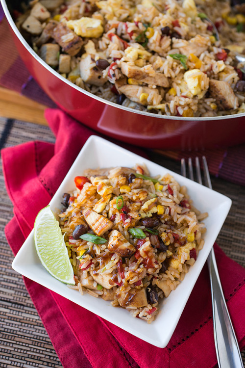 Fiesta Fried Rice with Blackened Chicken, Fire-Roasted Bell Peppers, Black Beans and Corn, drizzled 