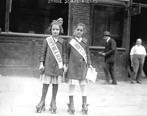 historium:Two young strike sympathizers on roller skates distribute leaflets in Union Square, NYC, 1