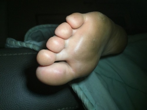 A friend and his girlfriend are staying over and she fell asleep with her feet hanging over the couc