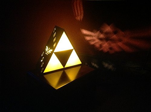nerdsandgamersftw:  Legend of  Zelda Triforce Lamp   Width: 9 inches Color: Black Material: Acrylic Finish Type: High Gloss Available for purchase via Amazon 