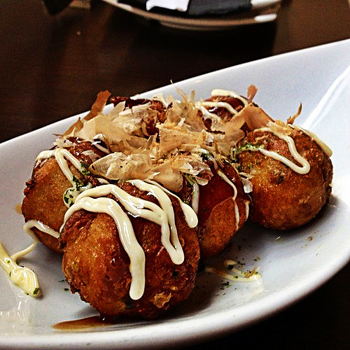 everybody-loves-to-eat:Takoyaki is a ball-shaped Japanese snack made of a wheat flour-based batter a