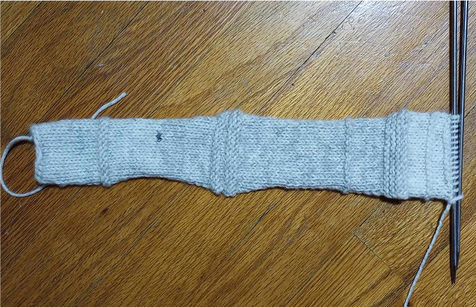 first half of a grey knitted headband