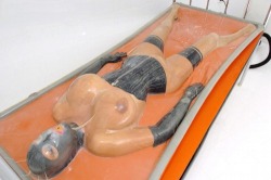 shinypet:  therubberdollowner:  http://therubberdollowner.tumblr.com A very shapely rubber doll in a gorgeous vacbed.  Please note, you don’t see a breathing tube but there is a mouth piece in between this rubber doll’s mouth.  One should not try