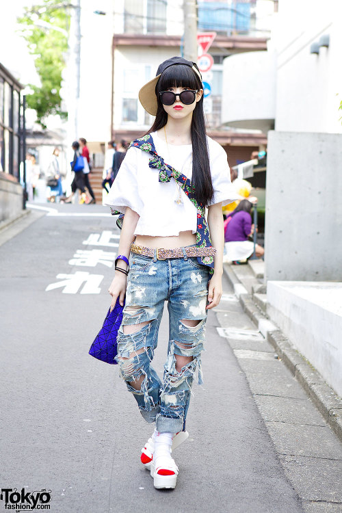 18-year-old Nori on the street in Harajuku wearing an I Tokyo Me crop top, ripped jeans from RNA, a 